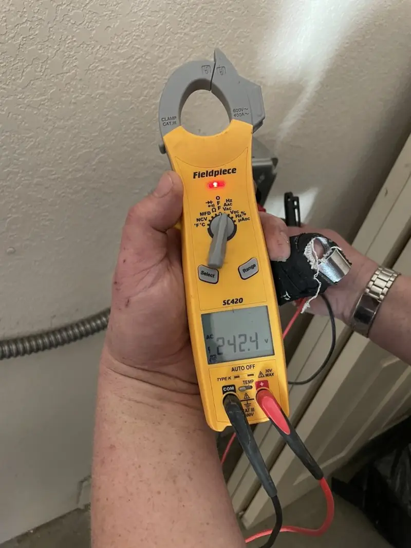 Voltage testing with clamp meter during Recessed Lighting Installation in Gulf Park Estates